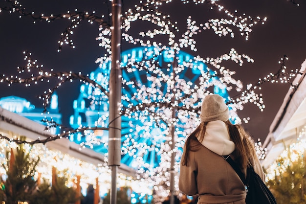 Free Photo girl posing against the background of decorated trees