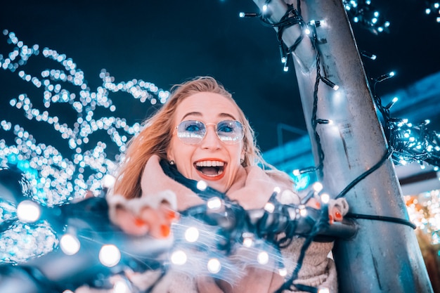 Girl posing against the background of decorated trees