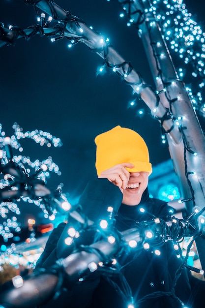 Free Photo girl posing against the background of decorated trees