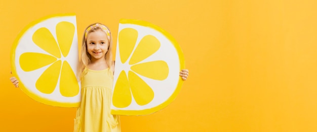 Girl posing with lemon slices decorations