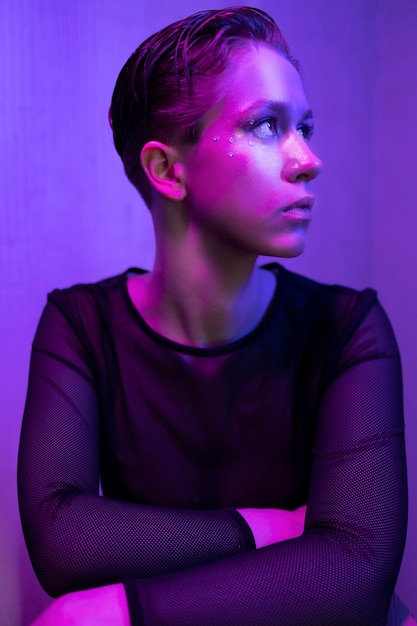 Free Photo girl posing with neon light front view