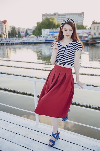 Free Photo girl posing with sea background in a seaport