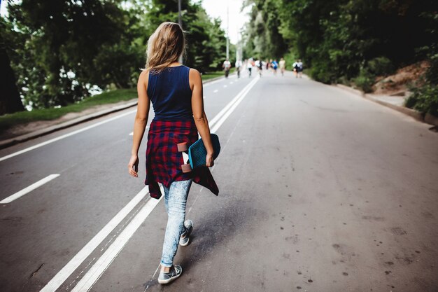 girl posing with skate board