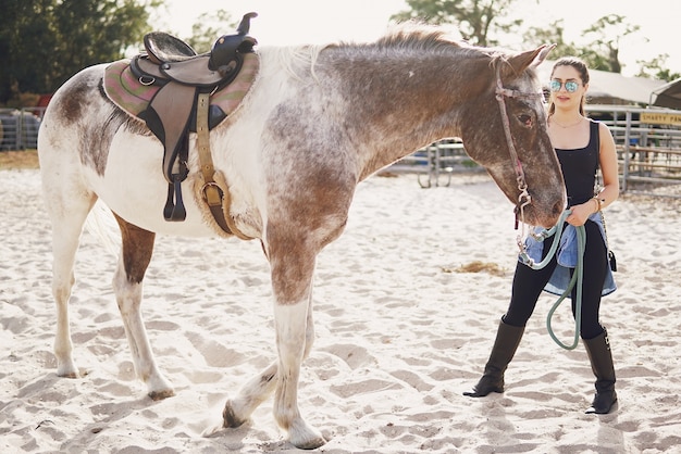 Free photo girl preparing to ride a horse