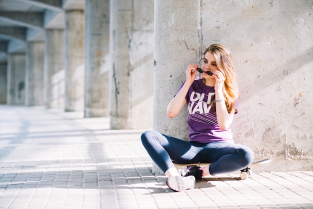 Girl putting sunglasses on