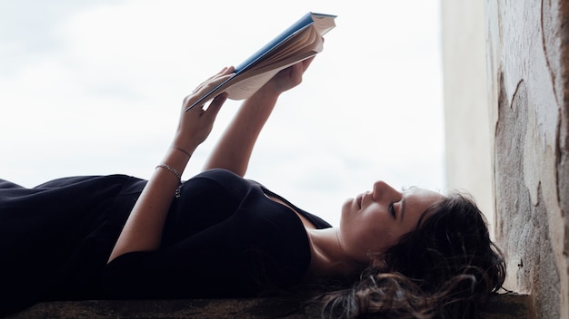 Girl reading a book face up