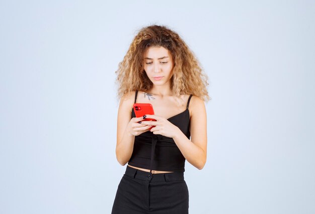 Free Photo girl reading her messages on the smartphone and looks thoughtful. 