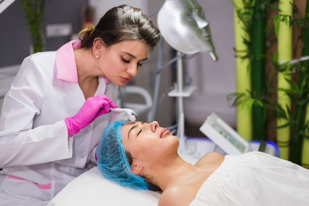 Girl receiving facial treatment in a beauty salon