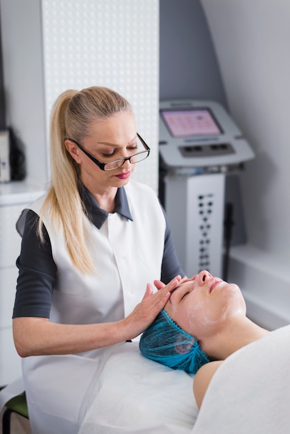 Free Photo girl receiving facial treatment in a beauty salon