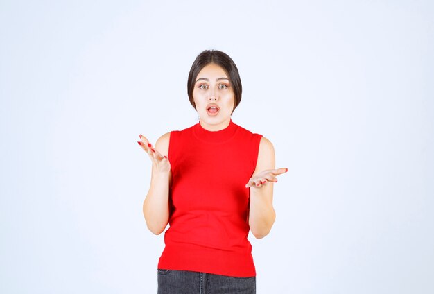 Girl in red shirt looks stressed and nervous.