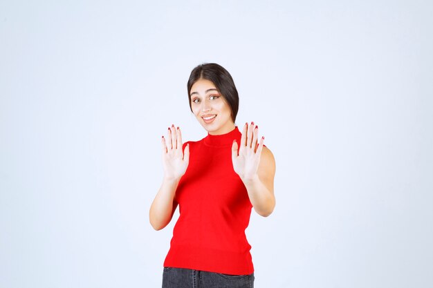 Girl in red shirt stopping someone.