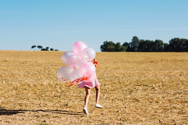 Free Photo girl running with bunch of balloons