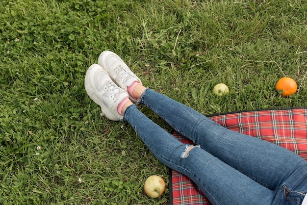 Girl's feet on a picnic blanket