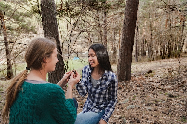 Girl showing a seed to her friend