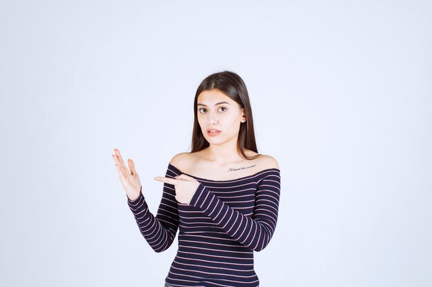 Girl showing something in her open hand. 