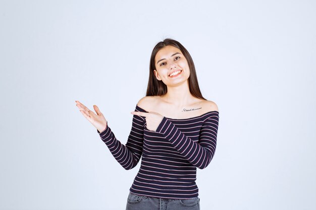 Girl showing something in her open hand. 