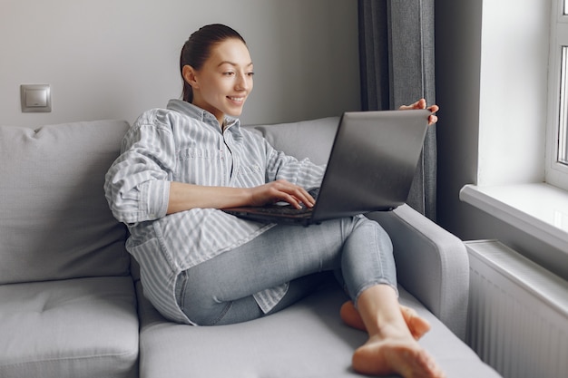 Free Photo girl sitting at home and use the laptop