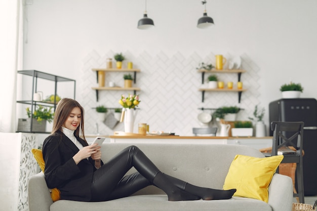 Girl sitting on the sofa and use the phone