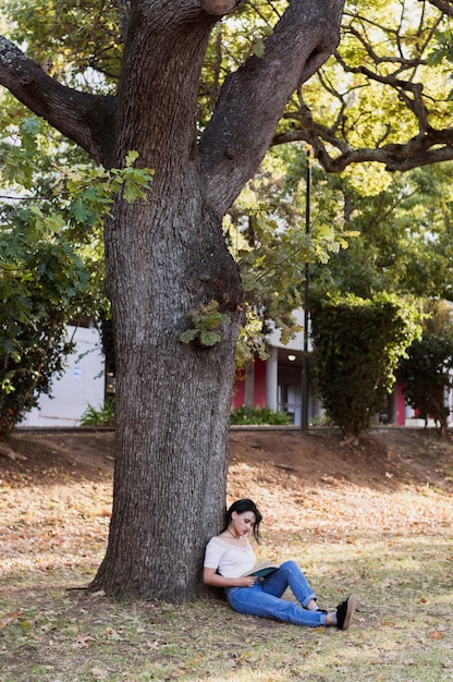 Girl sitting below a tree