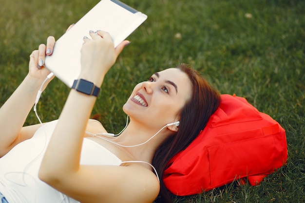 Free photo girl sitting in a university campus using a tablet