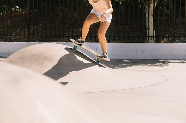 Girl skating over hill