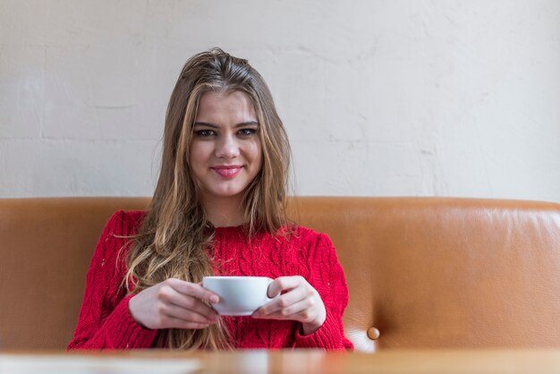 Girl smiling and holding a cup