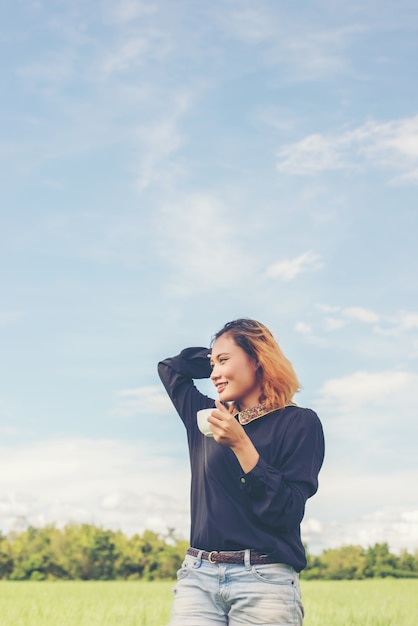 Girl smiling with a cup