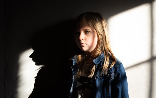 girl standing against the wall