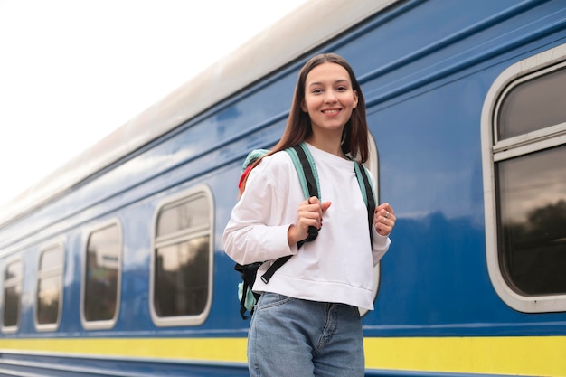 Girl standing next to the train low view