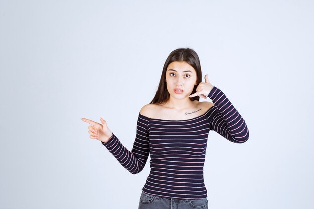 Girl in striped shirt showing call sign. 