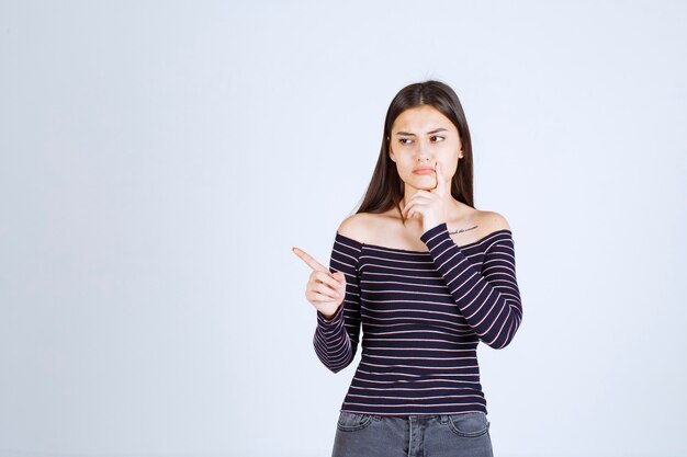 Girl in striped shirt thinking and brainstorming. 