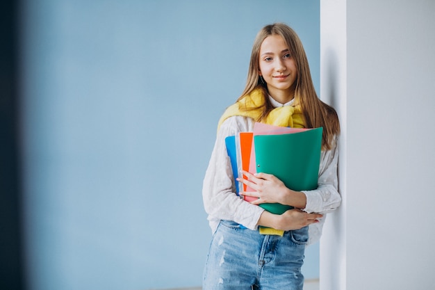 Free photo girl student standing with colorful folders