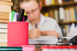 Free photo girl studying at desk with stationery