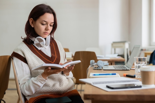 Girl studying from notebook alone during group study