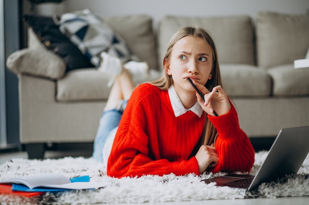 Free photo girl studying at home on the computer