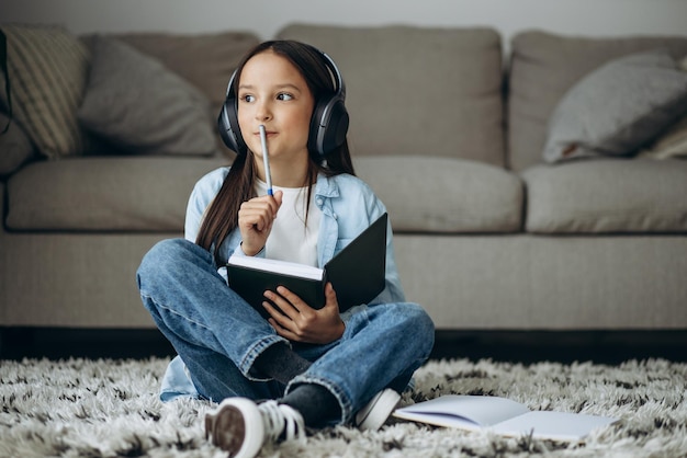 Girl studying at home and listening to music