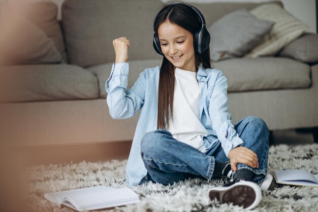 Girl studying at home and listening to music