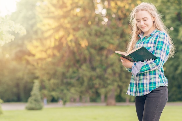 Girl studying with book in park