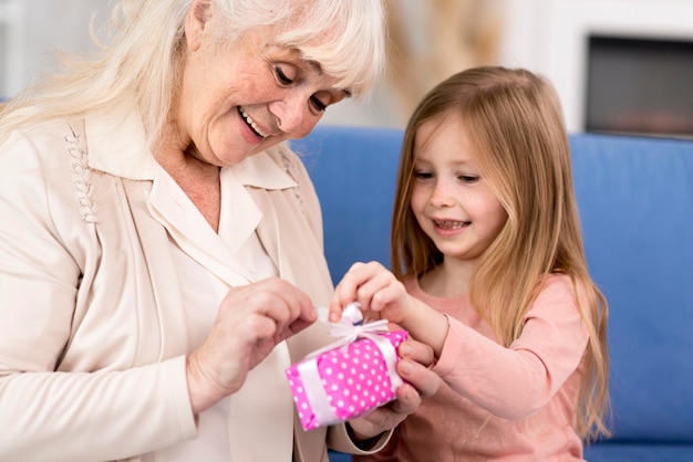 Girl surprising grandma with gift