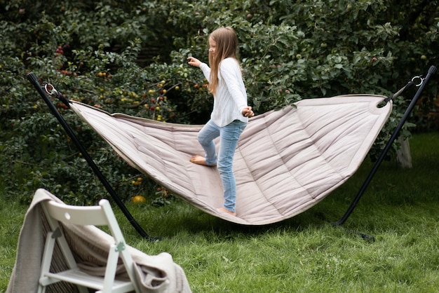 Free Photo girl swinging standing in a hammock