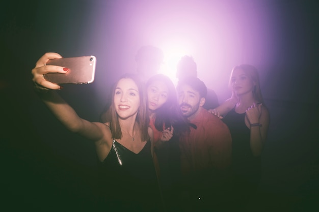 Free photo girl taking selfie in nightclub