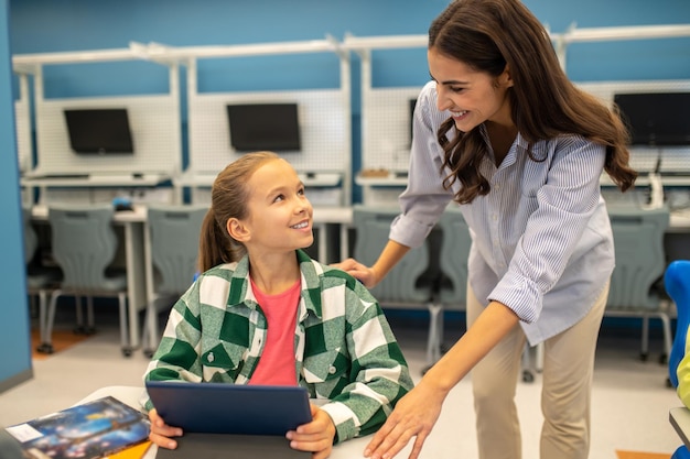 Free photo girl and teacher looking at each other