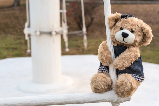 girl teddy bear hanging in playground