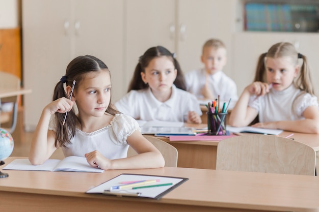 Girl thinking and looking away at lesson