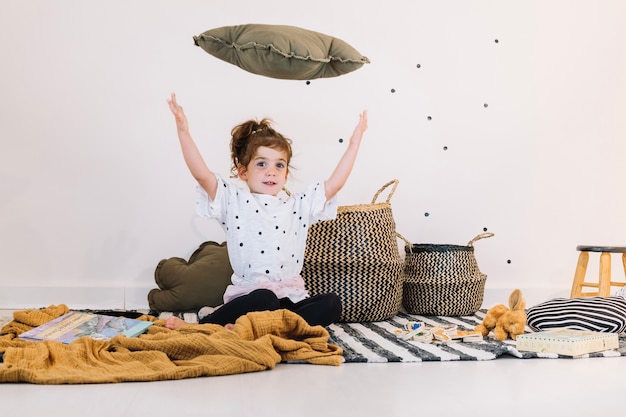 Free Photo girl throwing cushion