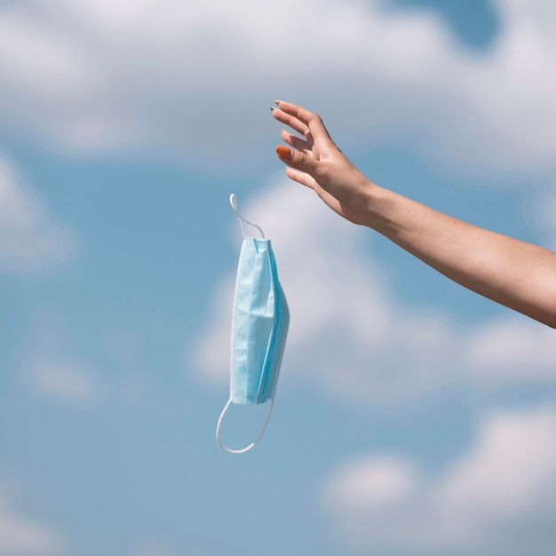 Free Photo girl throwing out a medical mask