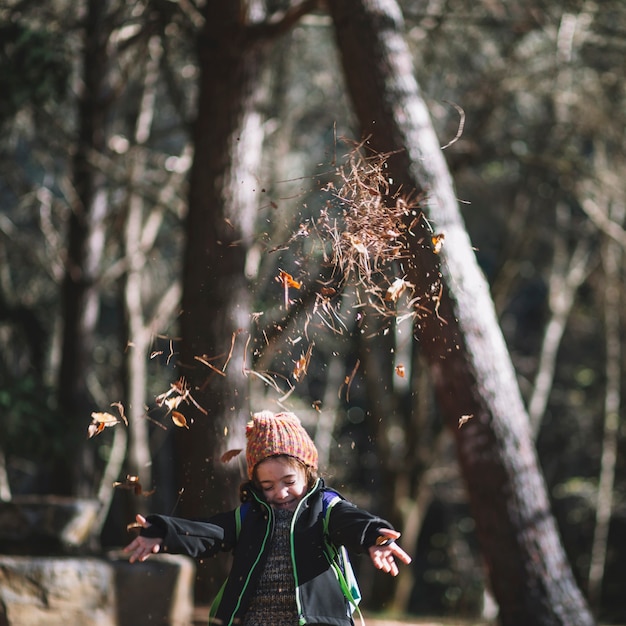 Free photo girl throwing up foliage