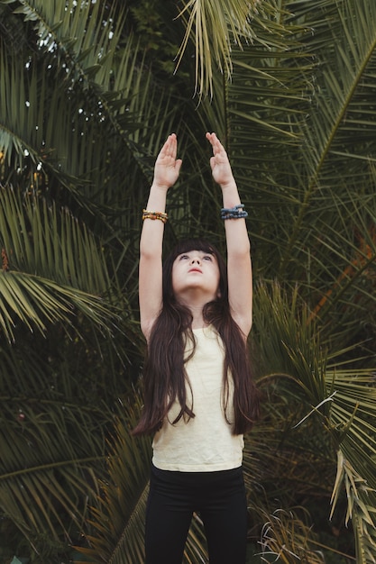 Girl in tree pose near palm