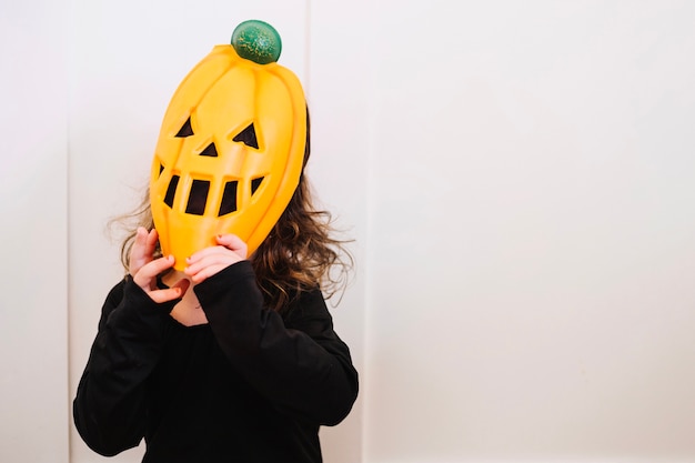 Free photo girl trying to remove mask