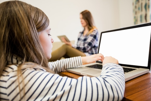 Girl using laptop in living room